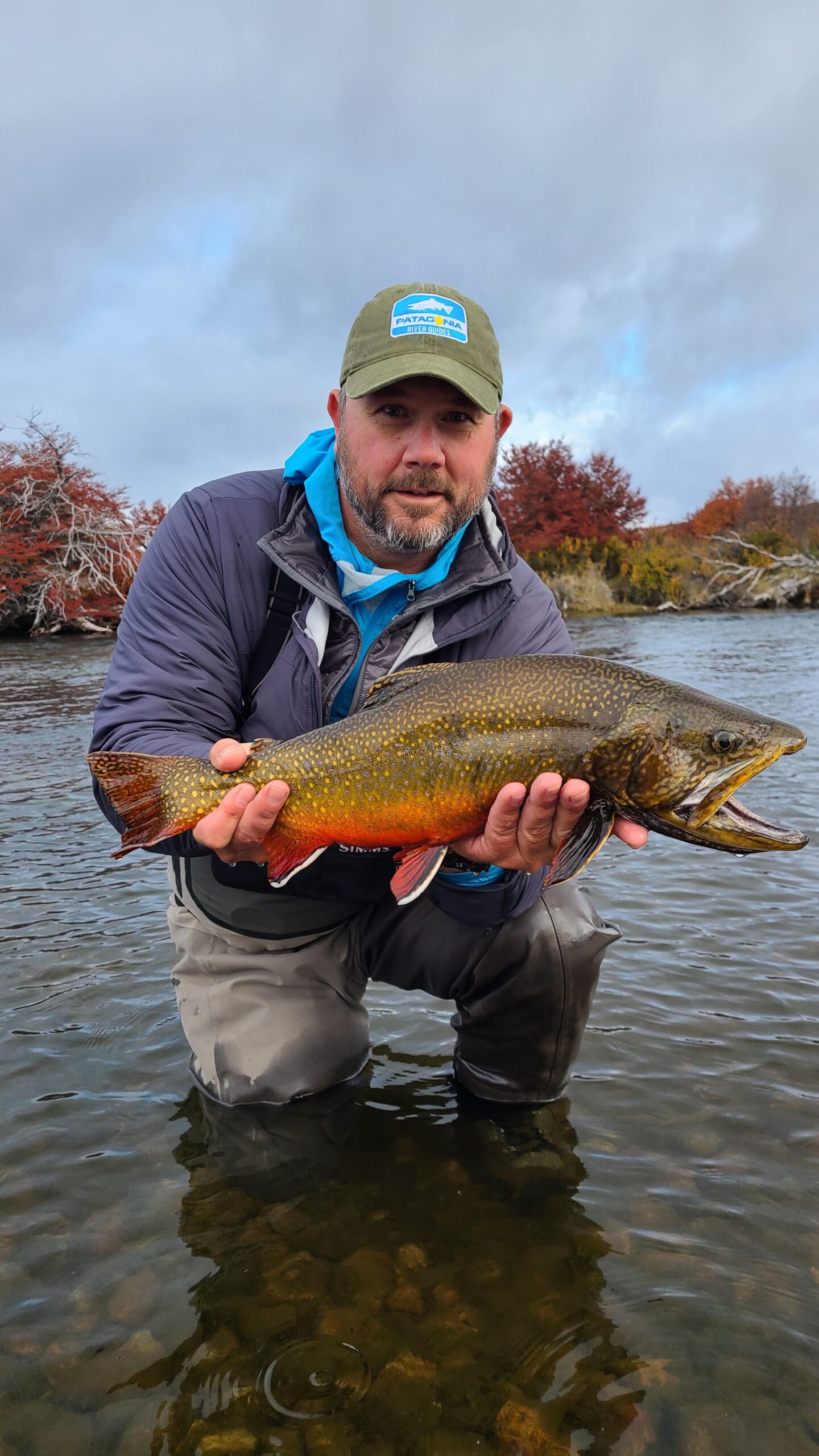 Outfitter Mike Agee holding a trout on the Missouri River.